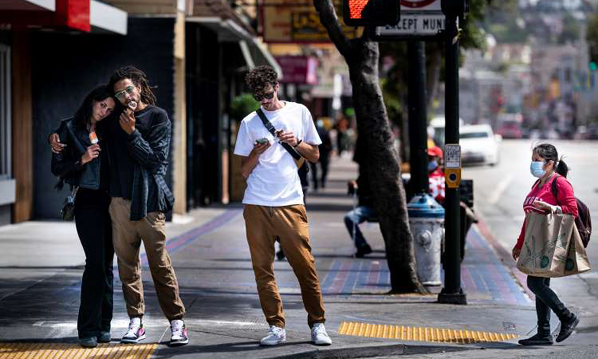 Một số người đi bộ không đeo khẩu trang trên phố Mission, thành phố San Francisco, tháng trước. Ảnh: Washington Post.